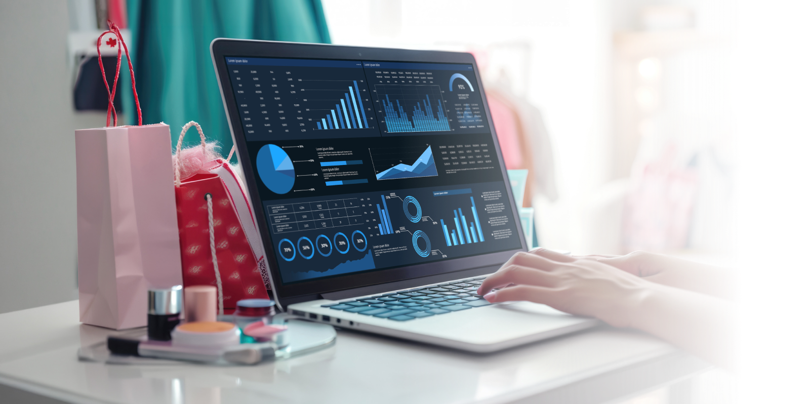 A person using a laptop and analyzing graphs and data