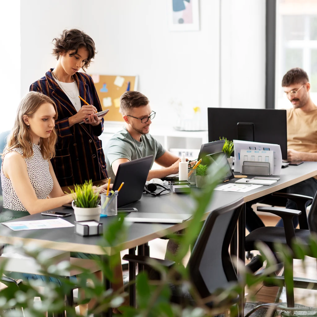 People working in the office, sitting at computer desks and dealing with IT services and IT consulting