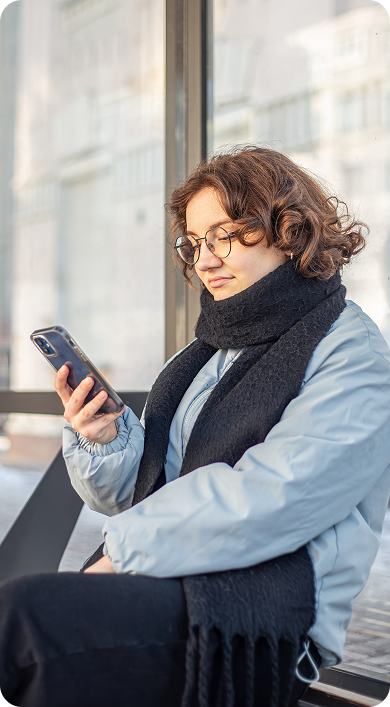 woman sitting and scrolling on her phone