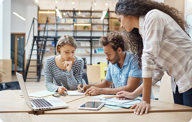 A small mixed group of professionals reviewing documents at a table