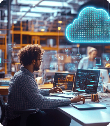 Developer analyzing code at a workstation with a glowing digital cloud icon overhead
