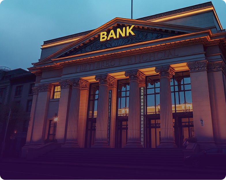 Illuminated classical bank building at night