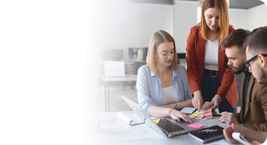 Recruitment team reviewing materials at a desk covered in sticky notes