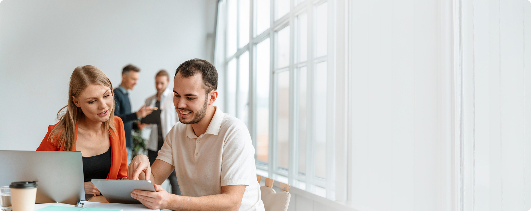 A business team reviewing data on a tablet